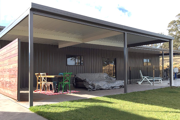 Furnished flat roof patio with partial side wall and green lawn