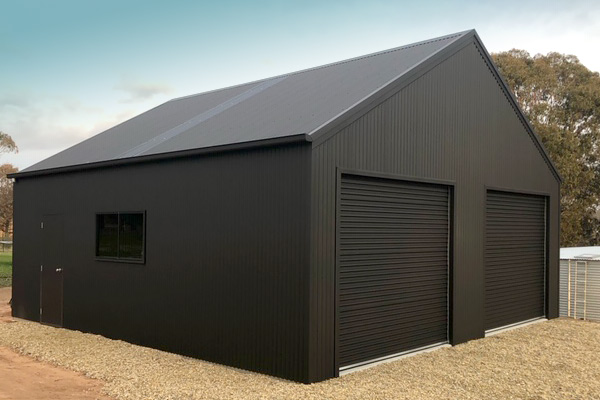 Double garage with two roller doors, side window and 30 degree gable roof, all in black