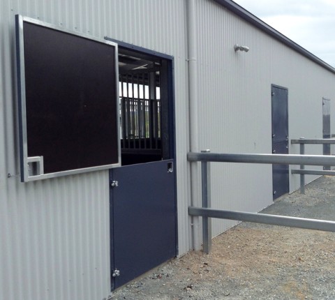 Day yard door on a horse stable with the top half open